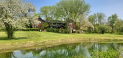 The Old Orchard Home surrounded by a small apple orchard, large meadows, and a private pond