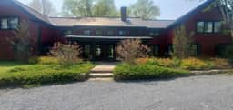 The Old Orchard Home surrounded by a small apple orchard, large meadows, and a private pond