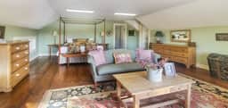 The Old Orchard Home surrounded by a small apple orchard, large meadows, and a private pond