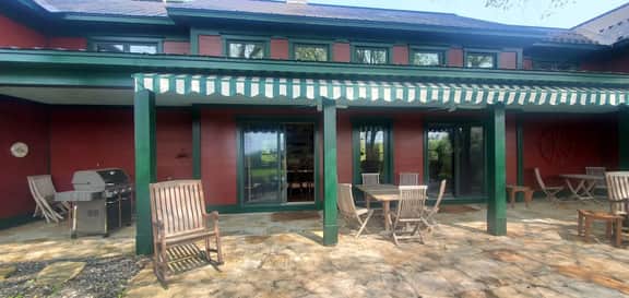 The Old Orchard Home surrounded by a small apple orchard, large meadows, and a private pond