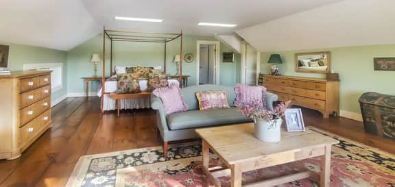 The Old Orchard Home surrounded by a small apple orchard, large meadows, and a private pond