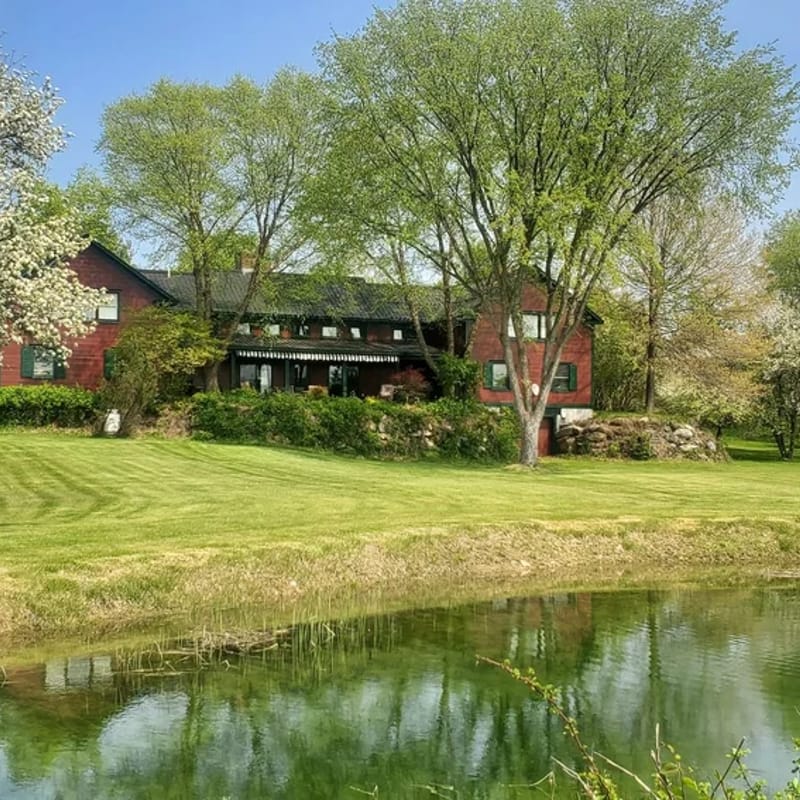 The Old Orchard Home surrounded by a small apple orchard, large meadows, and a private pond